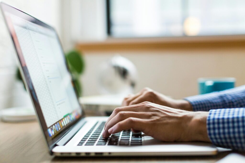 Person Typing On A Macbook